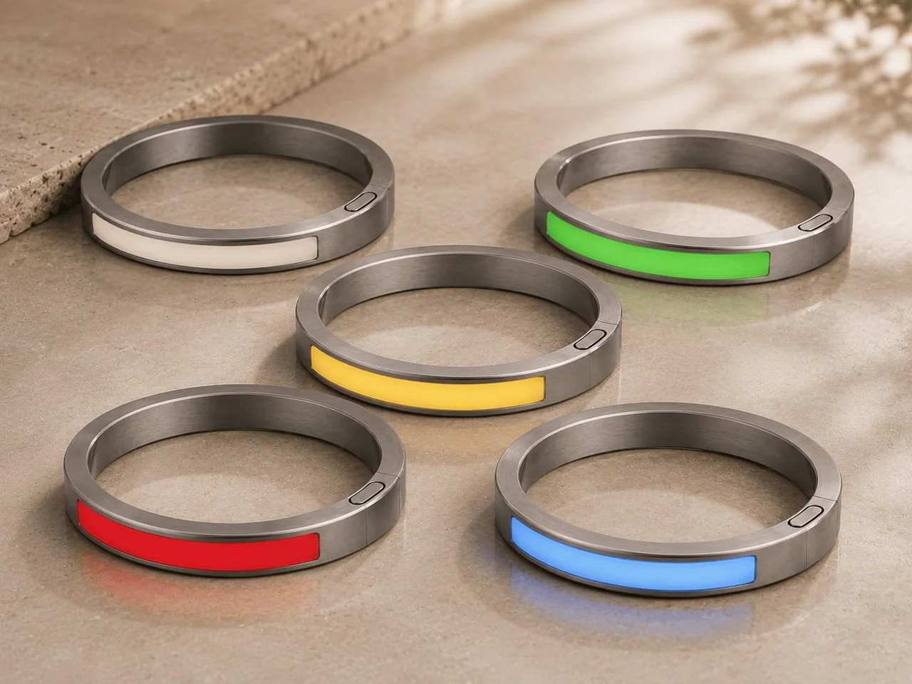 Five JUVEIL bangles showing the core ivory, green, yellow, red and blue palette.